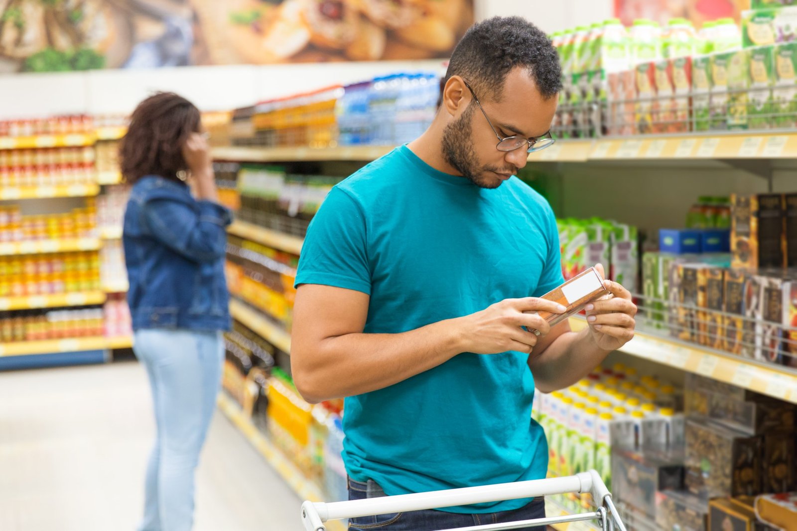 focused-african-american-man-reading-information-packaging-1-scaled