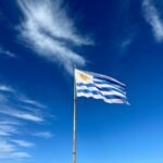 Bright colours, no other objects, just the sky and the flag